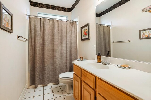 bathroom with toilet, tile patterned floors, and vanity