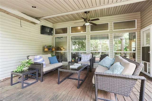 sunroom / solarium featuring an outdoor living space, a ceiling fan, and healthy amount of natural light