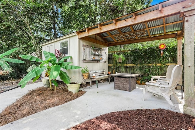 view of patio featuring fence and an outbuilding