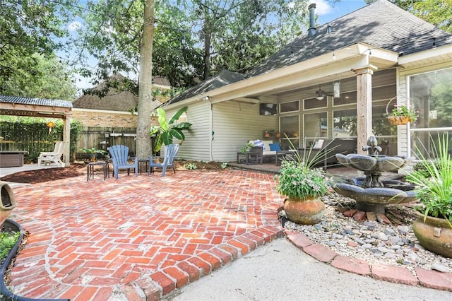 view of patio / terrace featuring fence and a ceiling fan
