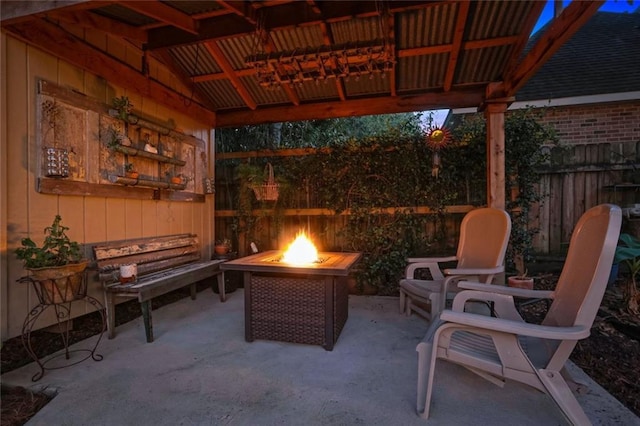 view of patio / terrace with a fire pit and fence