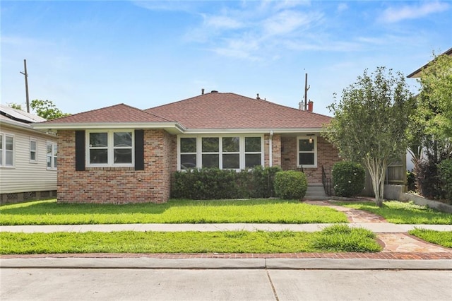 6415 Marshal Foch St, New Orleans, LA 70124 - view of front of home with brick siding, a front yard, and roof with shingles
