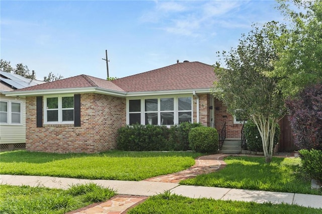 6415 Marshal Foch St, New Orleans, LA 70124 - view of front of house featuring a front lawn, brick siding, and roof with shingles