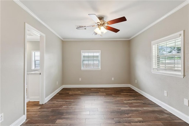 spare room featuring plenty of natural light, dark wood finished floors, ceiling fan, ornamental molding, and baseboards