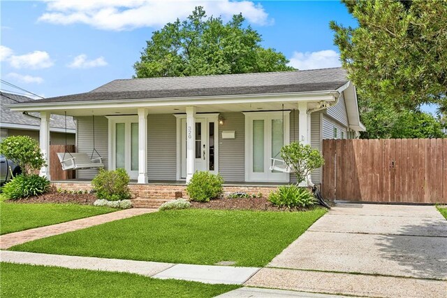 view of front of property with covered porch and roof with shingles