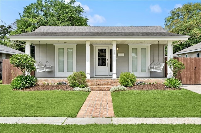 bungalow featuring a porch and a shingled roof