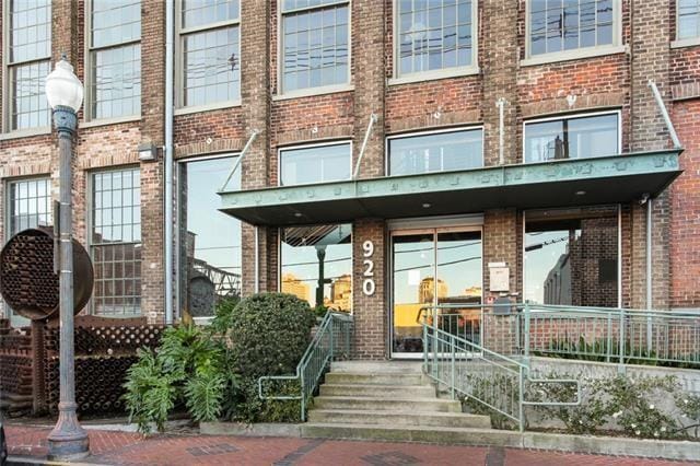 property entrance featuring brick siding