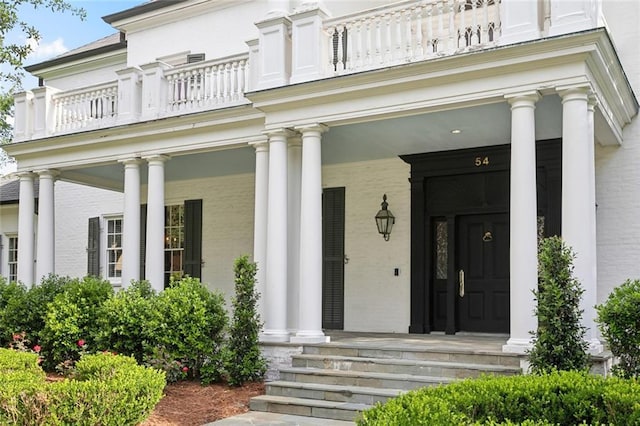 54 Beresford Dr, Metairie, LA 70001 - entrance to property featuring a balcony, a porch, and brick siding
