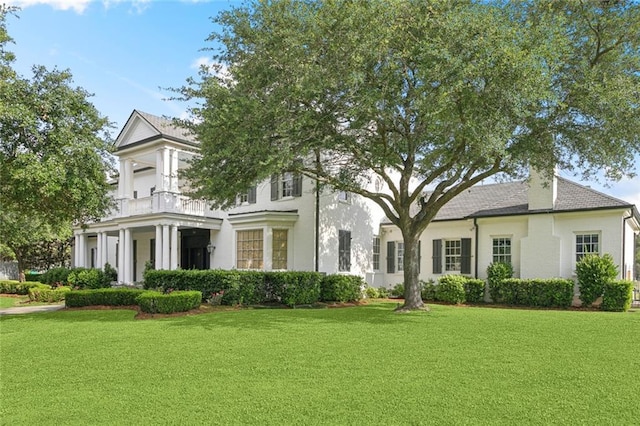 54 Beresford Dr, Metairie, LA 70001 - view of front of house featuring a front yard, a balcony, and stucco siding