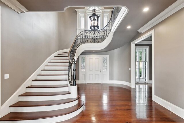54 Beresford Dr, Metairie, LA 70001 - entrance foyer featuring a chandelier, wood finished floors, baseboards, crown molding, and stairway