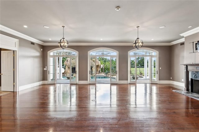 54 Beresford Dr, Metairie, LA 70001 - unfurnished living room featuring a high end fireplace, recessed lighting, baseboards, crown molding, and wood finished floors