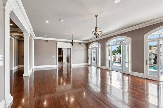 54 Beresford Dr, Metairie, LA 70001 - unfurnished living room featuring wood-type flooring, baseboards, recessed lighting, ornamental molding, and ornate columns