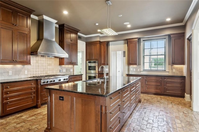 54 Beresford Dr, Metairie, LA 70001 - kitchen with wall chimney exhaust hood, stainless steel appliances, brick flooring, a sink, and a kitchen island with sink