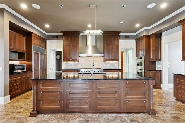 54 Beresford Dr, Metairie, LA 70001 - kitchen with wall chimney range hood, appliances with stainless steel finishes, a center island with sink, recessed lighting, and tasteful backsplash