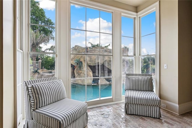 54 Beresford Dr, Metairie, LA 70001 - living area featuring baseboards, plenty of natural light, and brick flooring
