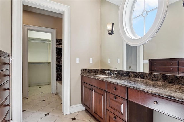 54 Beresford Dr, Metairie, LA 70001 - bathroom featuring vanity, tile patterned flooring, a bath, and baseboards