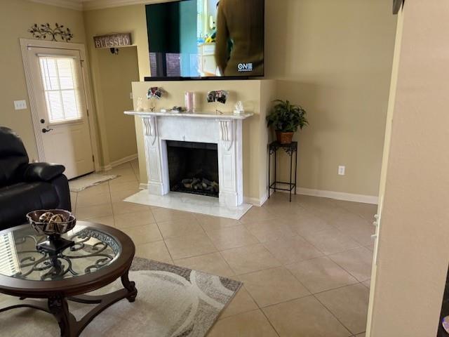 6342 Surrey Ln, Zachary, LA 70791 - living room featuring tile patterned flooring, a fireplace, baseboards, and crown molding