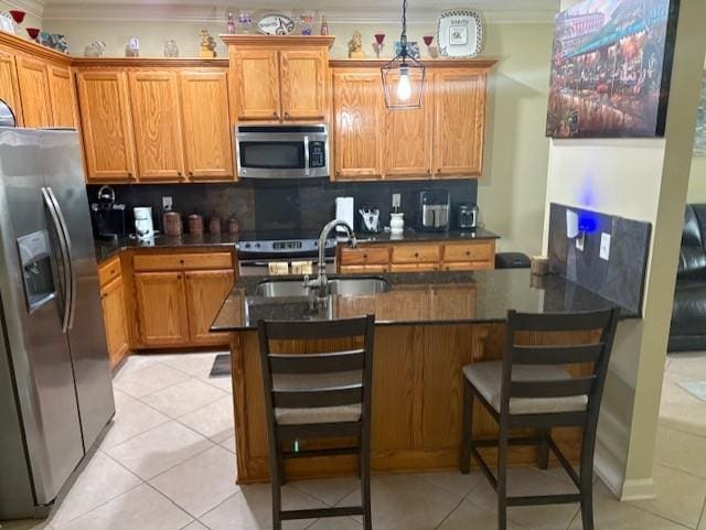 6342 Surrey Ln, Zachary, LA 70791 - kitchen featuring appliances with stainless steel finishes, ornamental molding, dark countertops, a sink, and light tile patterned flooring