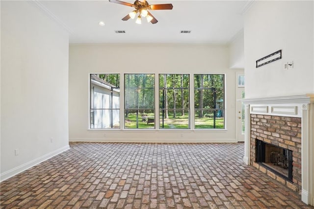 125 Secluded Forest Way, Madisonville, LA 70447 - unfurnished living room with a ceiling fan, baseboards, brick flooring, a fireplace, and ornamental molding