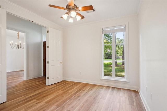 125 Secluded Forest Way, Madisonville, LA 70447 - empty room featuring crown molding, light wood finished floors, a chandelier, baseboards, and ceiling fan