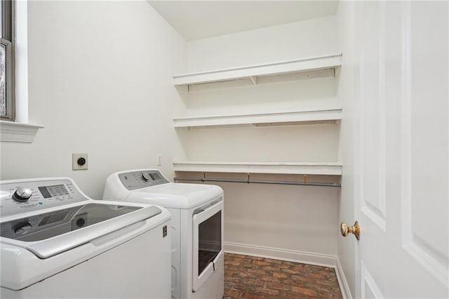 125 Secluded Forest Way, Madisonville, LA 70447 - clothes washing area with independent washer and dryer, baseboards, and brick patterned floors
