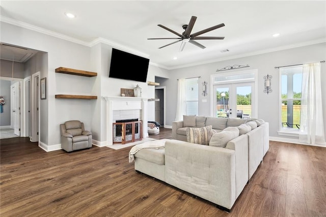 19916 Church Branch Rd, Springfield, LA 70462 - living room featuring ceiling fan, dark wood-style floors, attic access, crown molding, and a tile fireplace