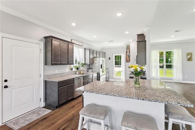 19916 Church Branch Rd, Springfield, LA 70462 - kitchen featuring stainless steel dishwasher, high end refrigerator, a breakfast bar, ornamental molding, and dark brown cabinets