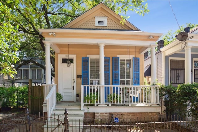8216 Spruce St, New Orleans, LA 70118 - shotgun-style home with a porch and fence