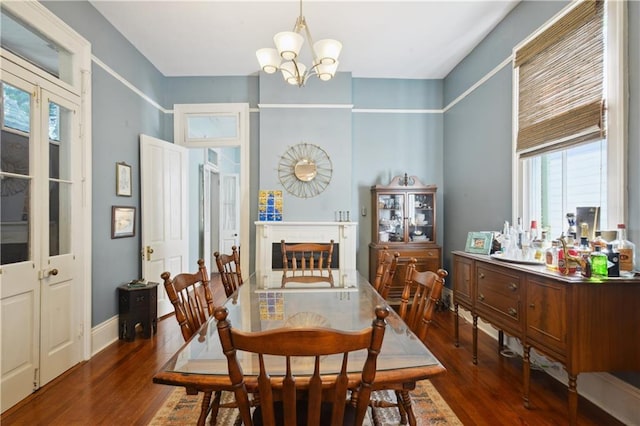 8216 Spruce St, New Orleans, LA 70118 - dining room featuring a chandelier, wood finished floors, and plenty of natural light