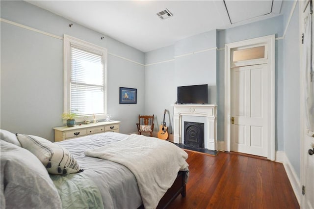 8216 Spruce St, New Orleans, LA 70118 - bedroom with wood finished floors and a fireplace with raised hearth