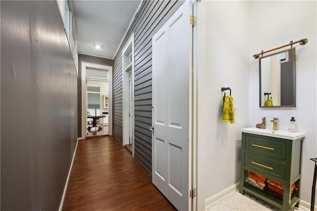 8216 Spruce St, New Orleans, LA 70118 - hall with baseboards, dark wood-type flooring, a sink, and recessed lighting