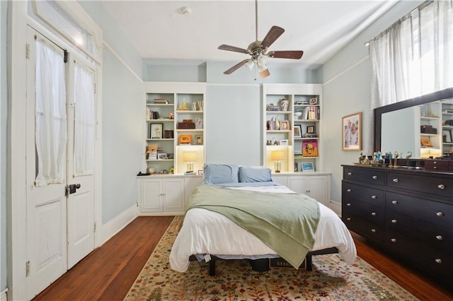 8216 Spruce St, New Orleans, LA 70118 - bedroom with dark wood-type flooring, ceiling fan, and baseboards