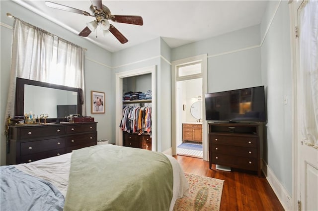 8216 Spruce St, New Orleans, LA 70118 - bedroom with wood finished floors, a closet, ensuite bath, ceiling fan, and a walk in closet
