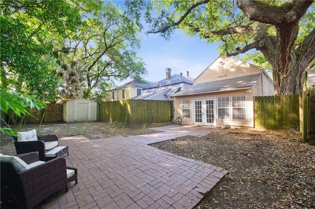 8216 Spruce St, New Orleans, LA 70118 - rear view of house featuring french doors, a patio area, a fenced backyard, a shed, and an outdoor structure