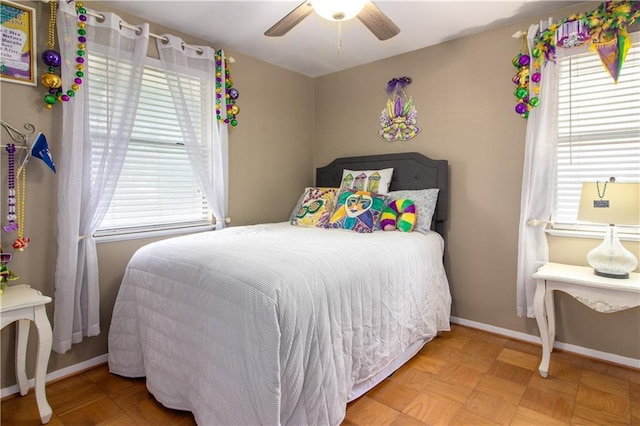 bedroom with multiple windows, baseboards, and ceiling fan