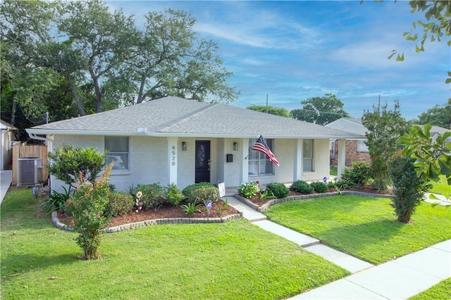 ranch-style house featuring central air condition unit, a front yard, brick siding, and a shingled roof