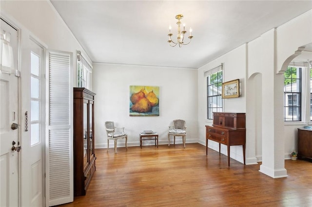 403 Athania Pkwy, Metairie, LA 70001 - entryway with arched walkways, plenty of natural light, a chandelier, and wood-type flooring