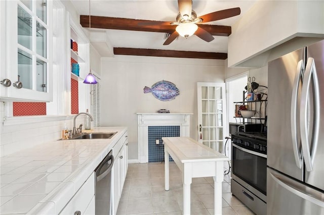 403 Athania Pkwy, Metairie, LA 70001 - kitchen featuring appliances with stainless steel finishes, tile countertops, a sink, white cabinetry, and ceiling fan