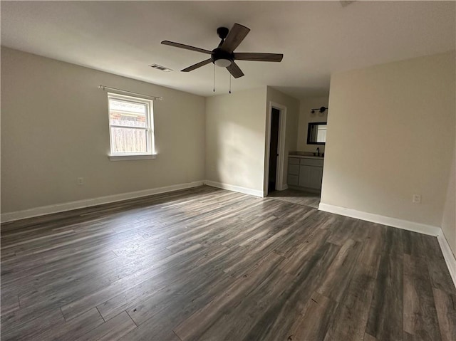 1561 Curtis St, Harvey, LA 70058 - empty room with dark wood finished floors, ceiling fan, and baseboards