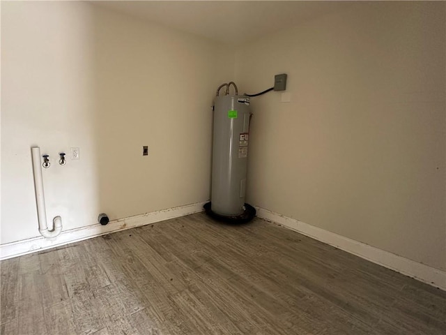 1561 Curtis St, Harvey, LA 70058 - laundry area featuring electric water heater, wood finished floors, and baseboards