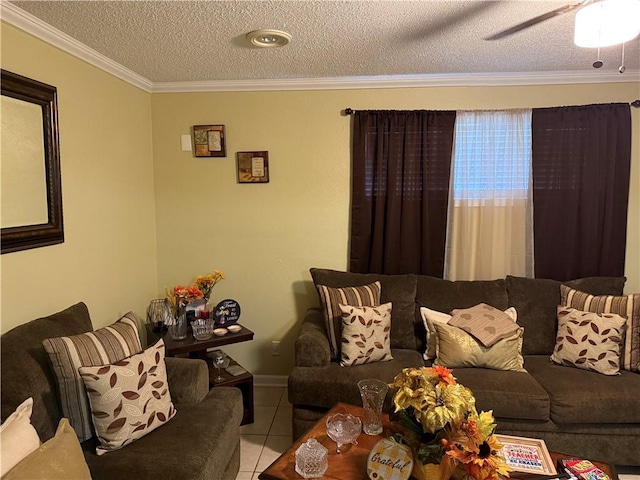 tiled living room with ornamental molding, a textured ceiling, ceiling fan, and baseboards
