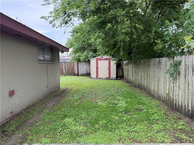 view of yard featuring a storage unit and an outbuilding