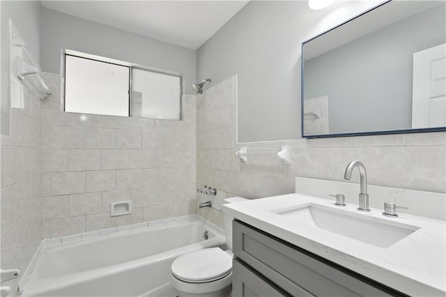 4933 Sanford St, Metairie, LA 70006 - bathroom with tub / shower combination, toilet, vanity, and tile walls