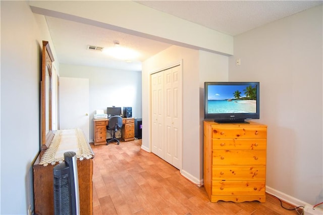 interior space featuring light wood-style flooring and baseboards