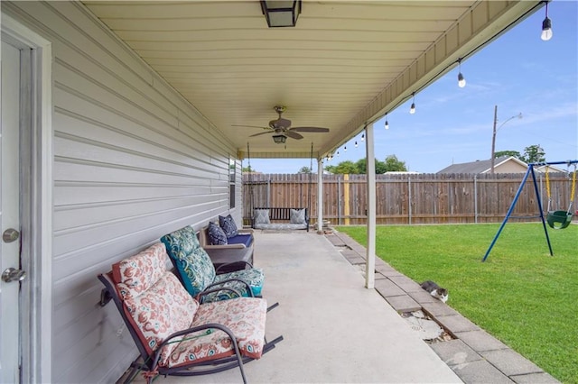 view of patio featuring a playground and a ceiling fan