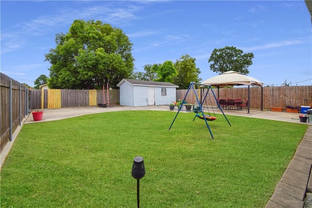 view of yard with a patio area, an outdoor structure, a gazebo, and a playground