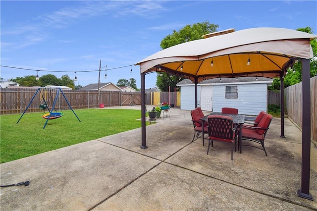 view of patio with a gazebo, outdoor dining area, and a playground