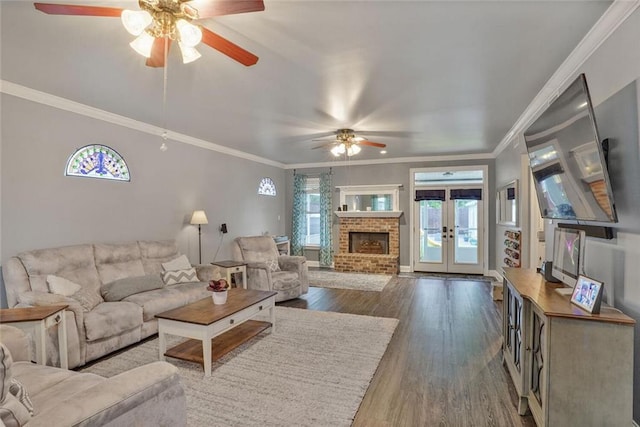 700 Kent Ave, Metairie, LA 70001 - living room with a ceiling fan, wood finished floors, french doors, ornamental molding, and a fireplace