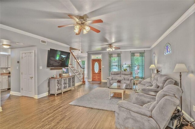 700 Kent Ave, Metairie, LA 70001 - living area with stairs, ceiling fan, wood finished floors, baseboards, and ornamental molding