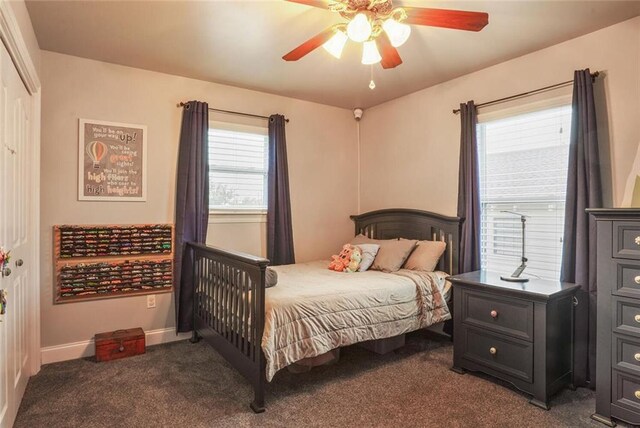 700 Kent Ave, Metairie, LA 70001 - bedroom with dark colored carpet, multiple windows, ceiling fan, and baseboards